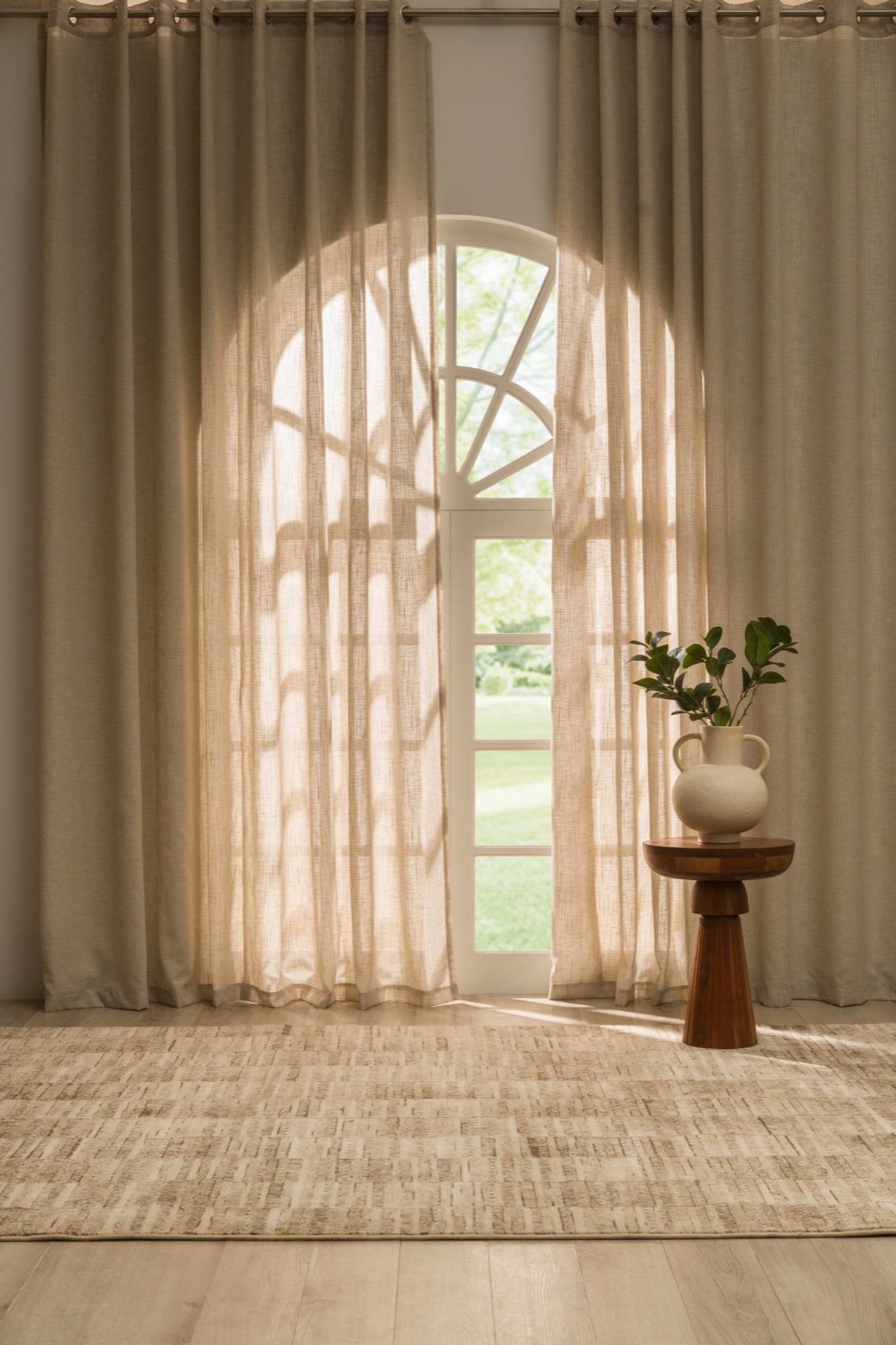 Natural sheer curtains at an arched window