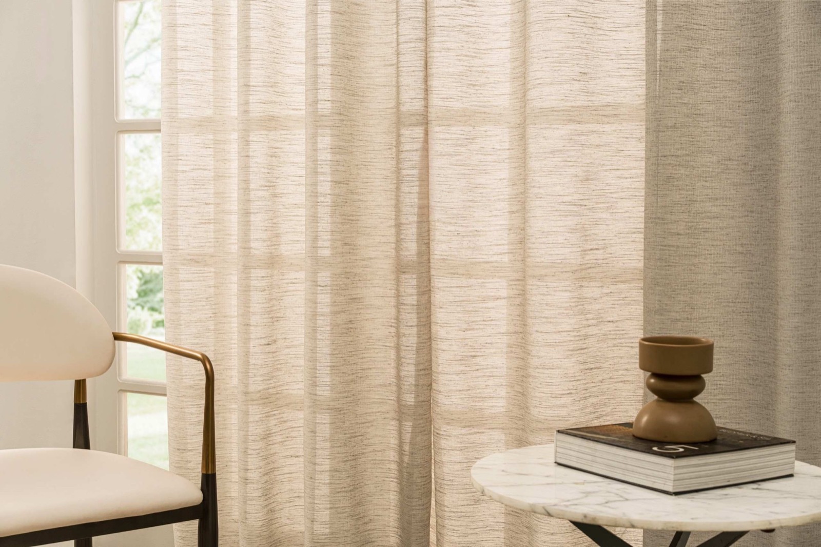 Close view of softly textured neutral curtain fabric